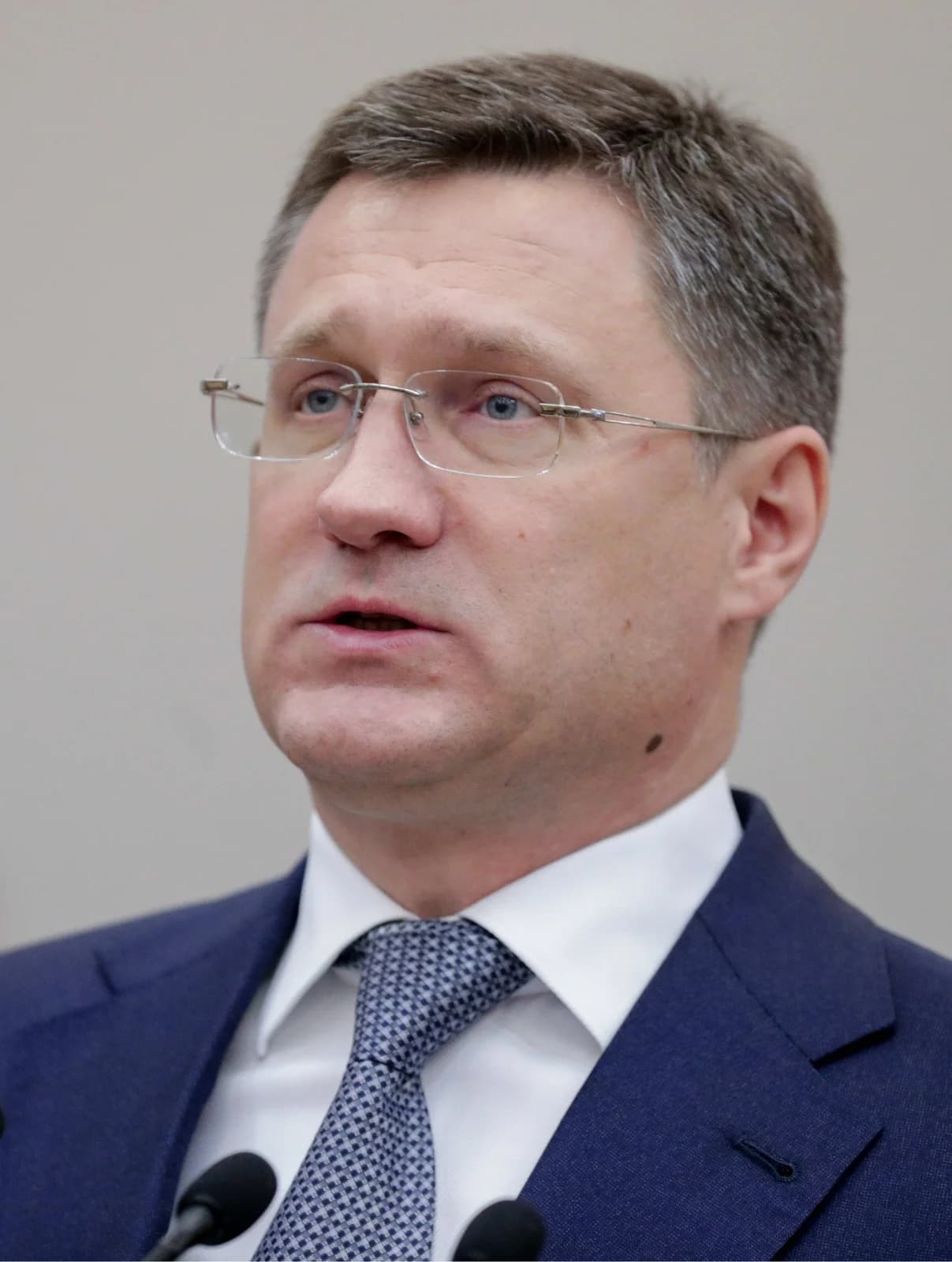 Alexander Novak, former Russian Minister of Energy, speaking at microphones.