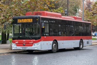 Red public transit bus, number 213e, with 'Plaza Italia' destination displayed.