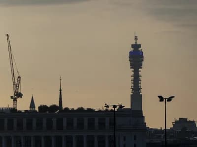 BT Tower silhouette against an orange-hued sunset sky.