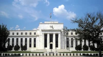 Marriner S. Eccles Federal Reserve Board Building exterior with American flag flying.