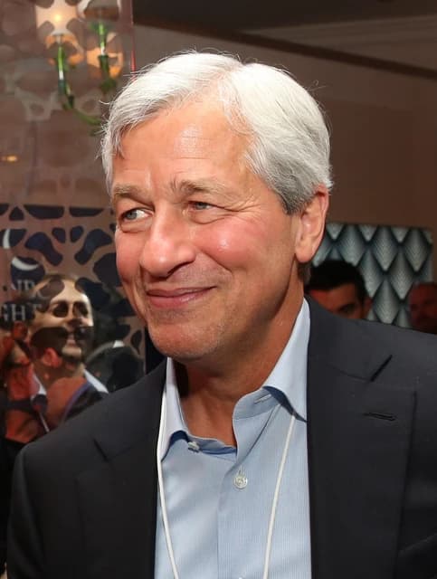 Jamie Dimon, CEO of JPMorgan Chase, smiling while looking towards the left.