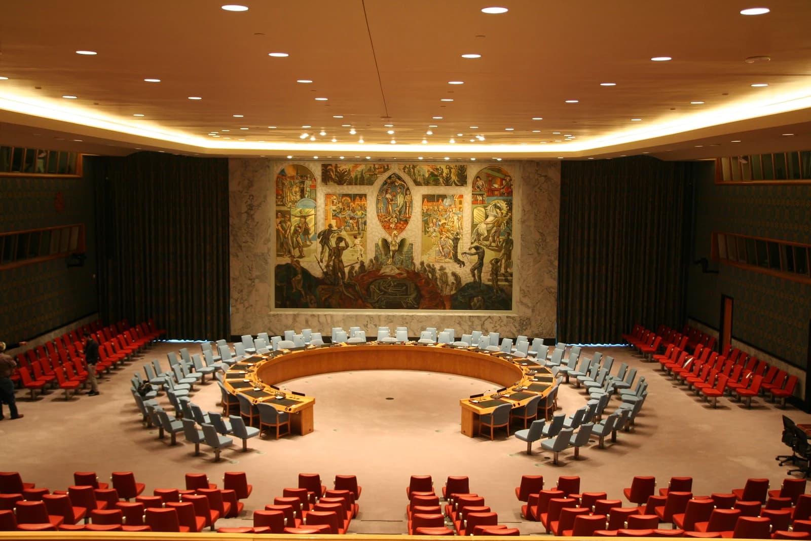 The United Nations Security Council chamber in New York City with blue and red seating.