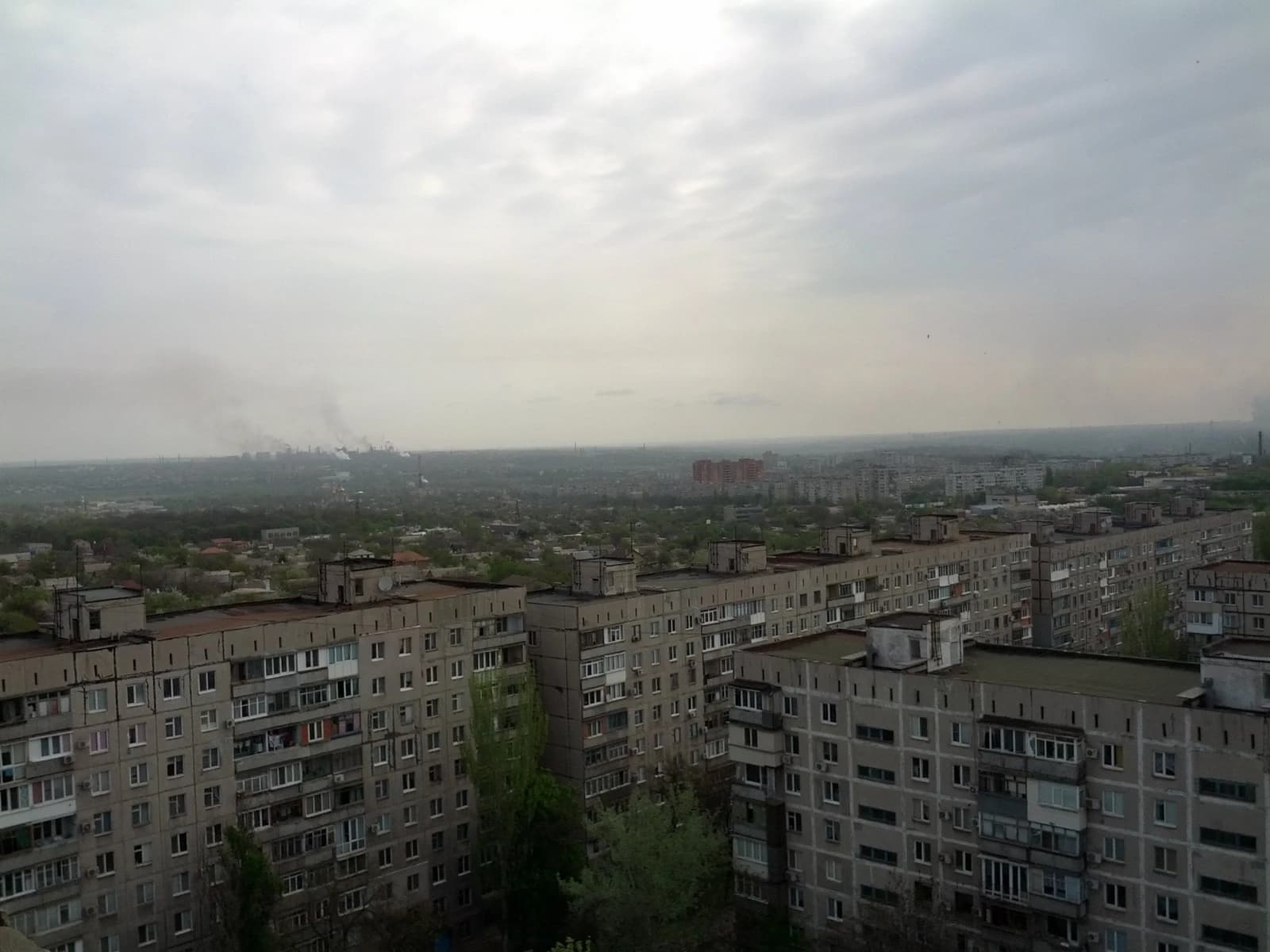 Overview of residential buildings and industrial skyline in Mariupol, Ukraine.