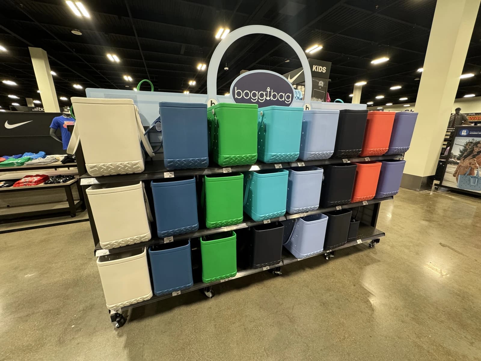 Colorful Bogg Bag tote bags displayed on shelves in a retail store.