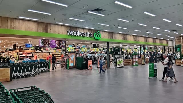 Shoppers walk through the entrance of a Woolworths supermarket in Cannington.