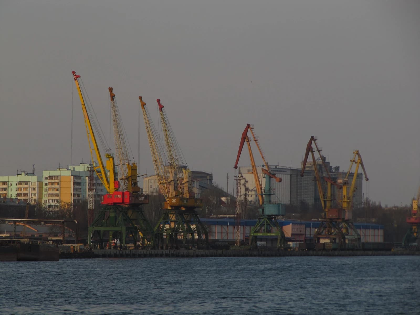 Cranes and a grain elevator at the Mykolaiv Commercial Sea Port, Ukraine.