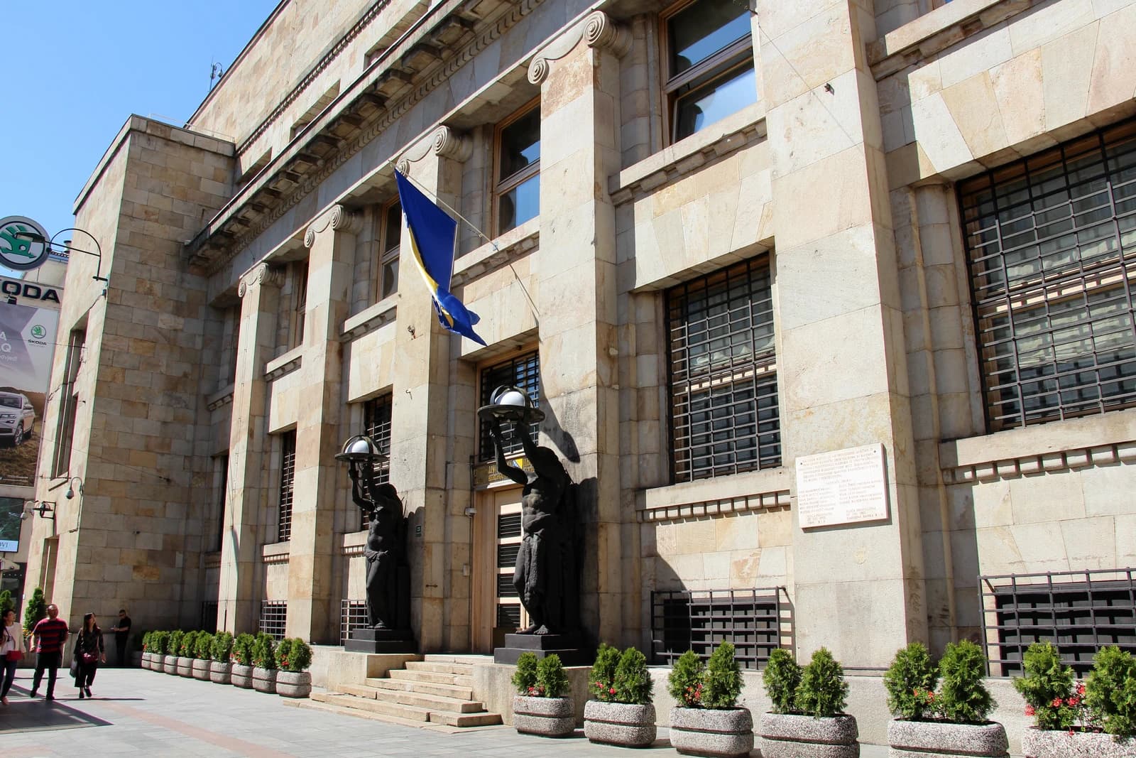 Exterior facade of the Central Bank of Bosnia and Herzegovina building with a flag flying.