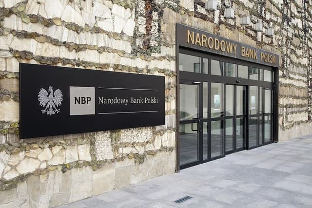 Exterior view of the Narodowy Bank Polski building, featuring its main entrance and signage.