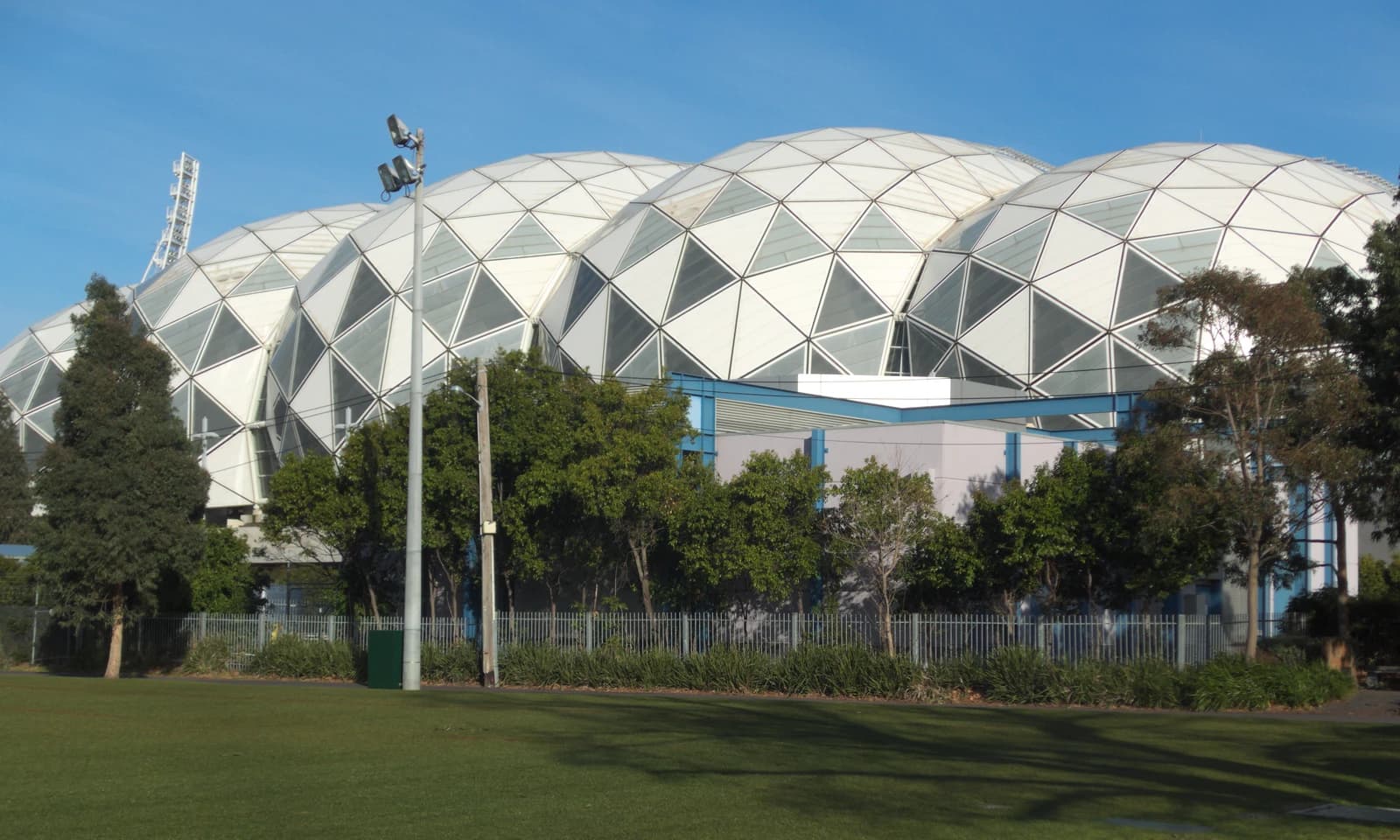 Exterior view of AAMI Park stadium in Melbourne with a clear blue sky.