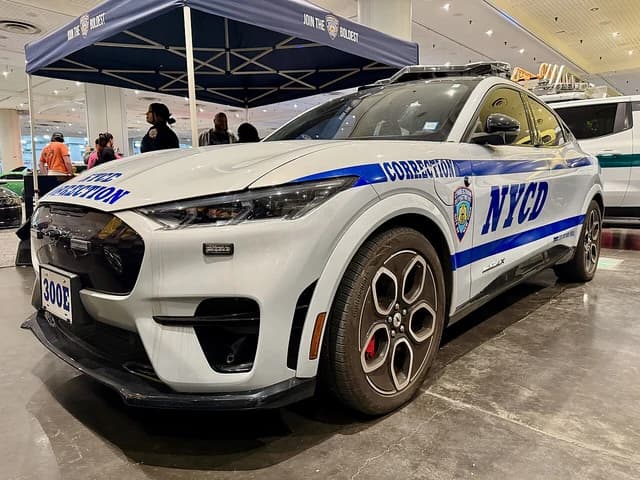 White Ford Mustang Mach-E GT vehicle with 'NYC Department of Correction' markings.