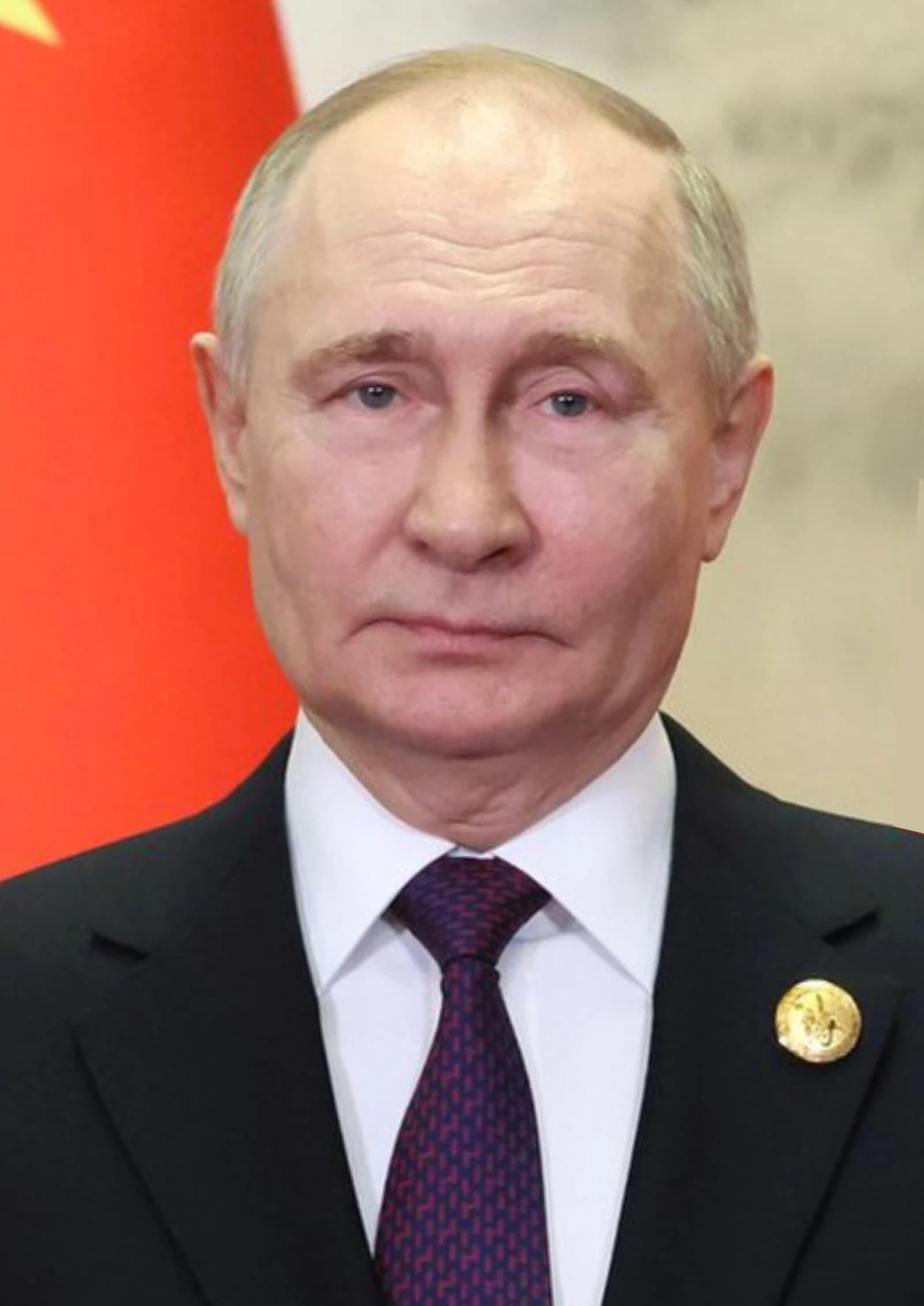 Russian President Vladimir Putin looking forward in a formal setting.