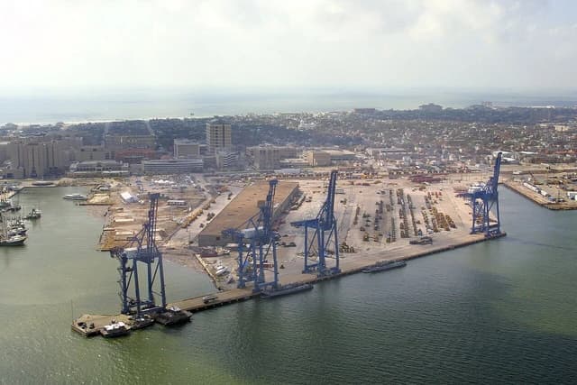 Aerial view of the bustling Port of Galveston, Texas, showing numerous cranes and cargo.