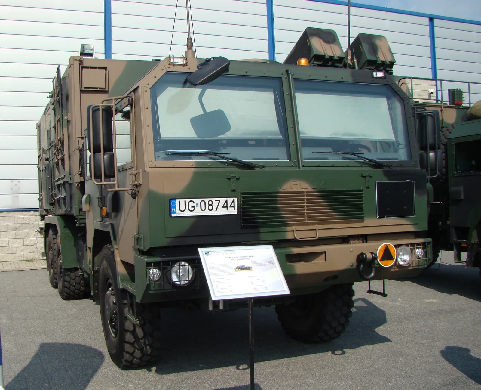 Jelcz 662D35 CCV military truck parked on asphalt pavement during an event.