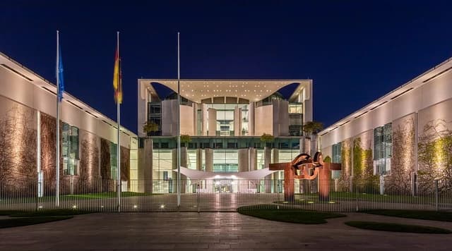Federal Chancellery building in Berlin, Germany, illuminated at night.