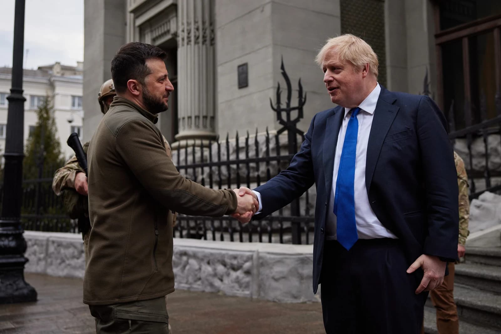 Ukrainian President Volodymyr Zelenskyy and UK Prime Minister Boris Johnson shaking hands outdoors.