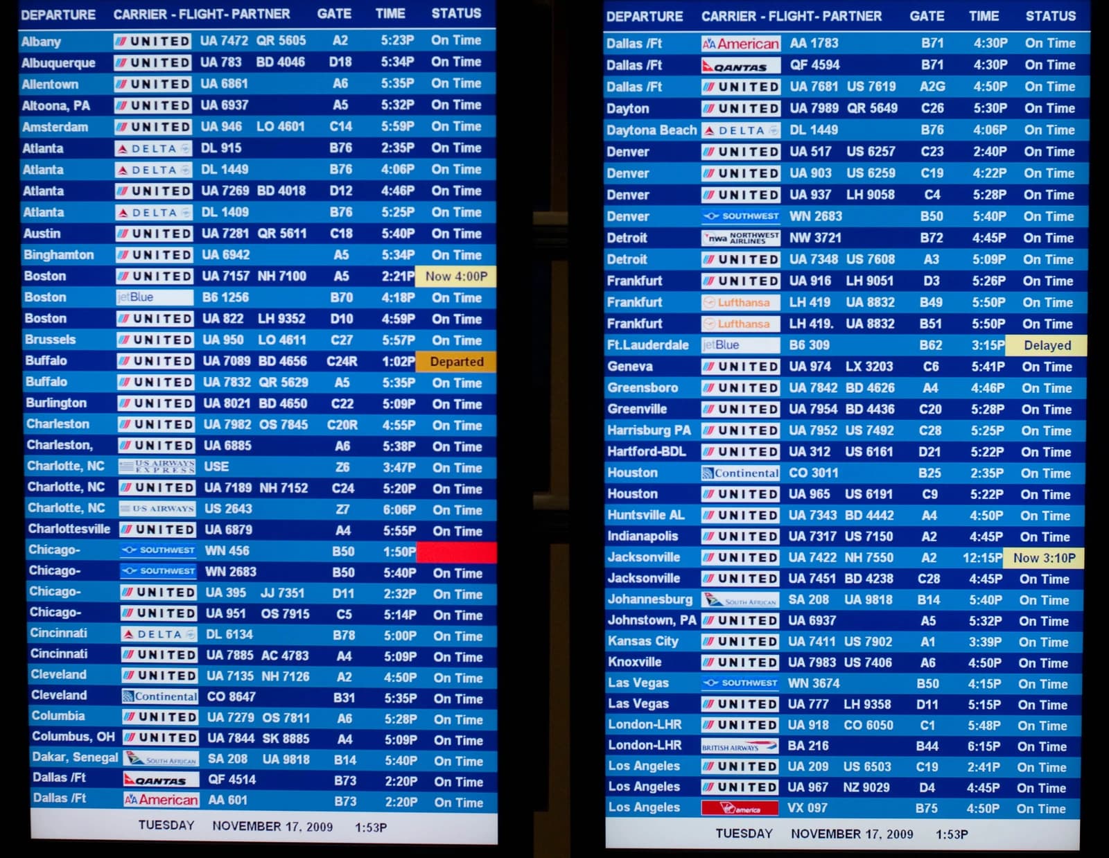 An electronic flight information display board showing departure and arrival times and statuses.