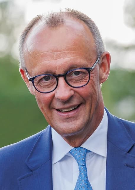 Friedrich Merz, German politician, smiling and looking towards the camera.