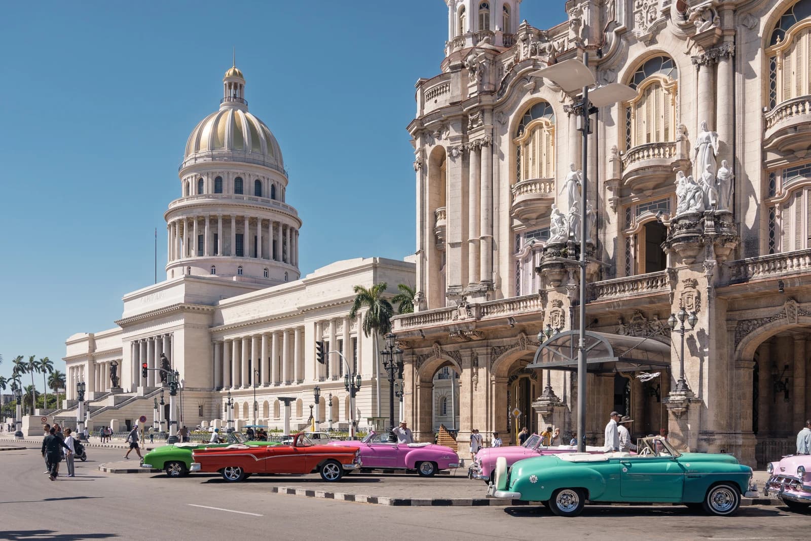 National Capitol Building with vintage cars on a street in Havana, Cuba.