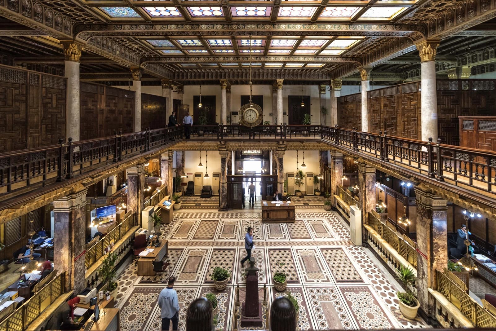 Grand interior hall of the Main Bank of Egypt with ornate wooden and tiled decor.