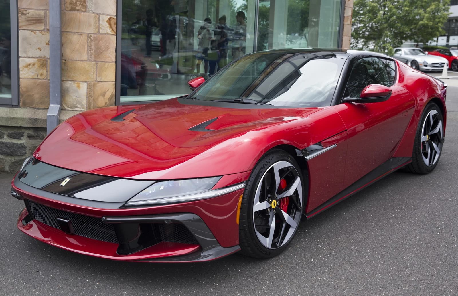Ferrari 12Cilindri sports car, in red, shown from the front left angle.