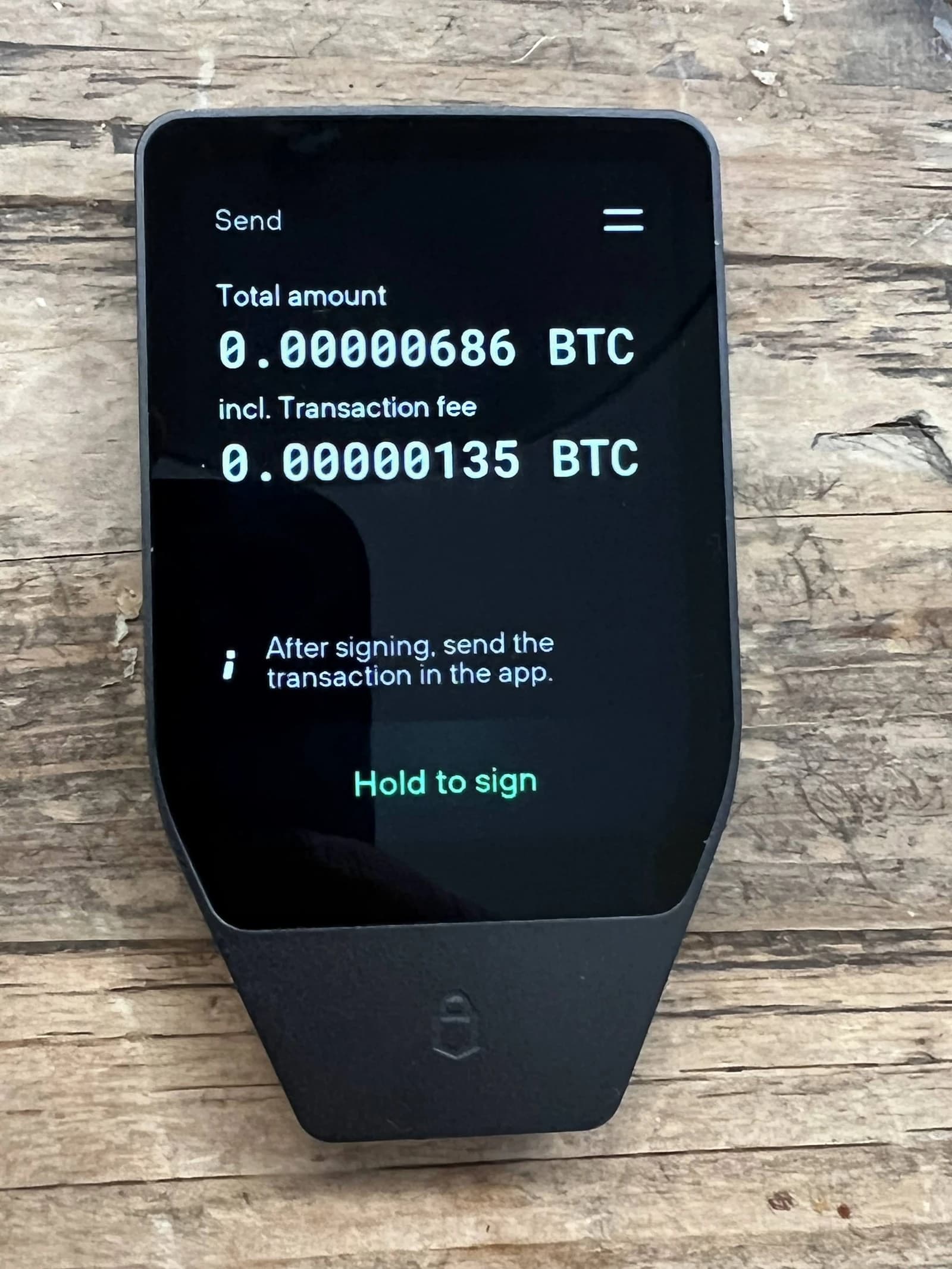 Trezor Safe 3 hardware wallet screen showing a small Bitcoin transaction amount.