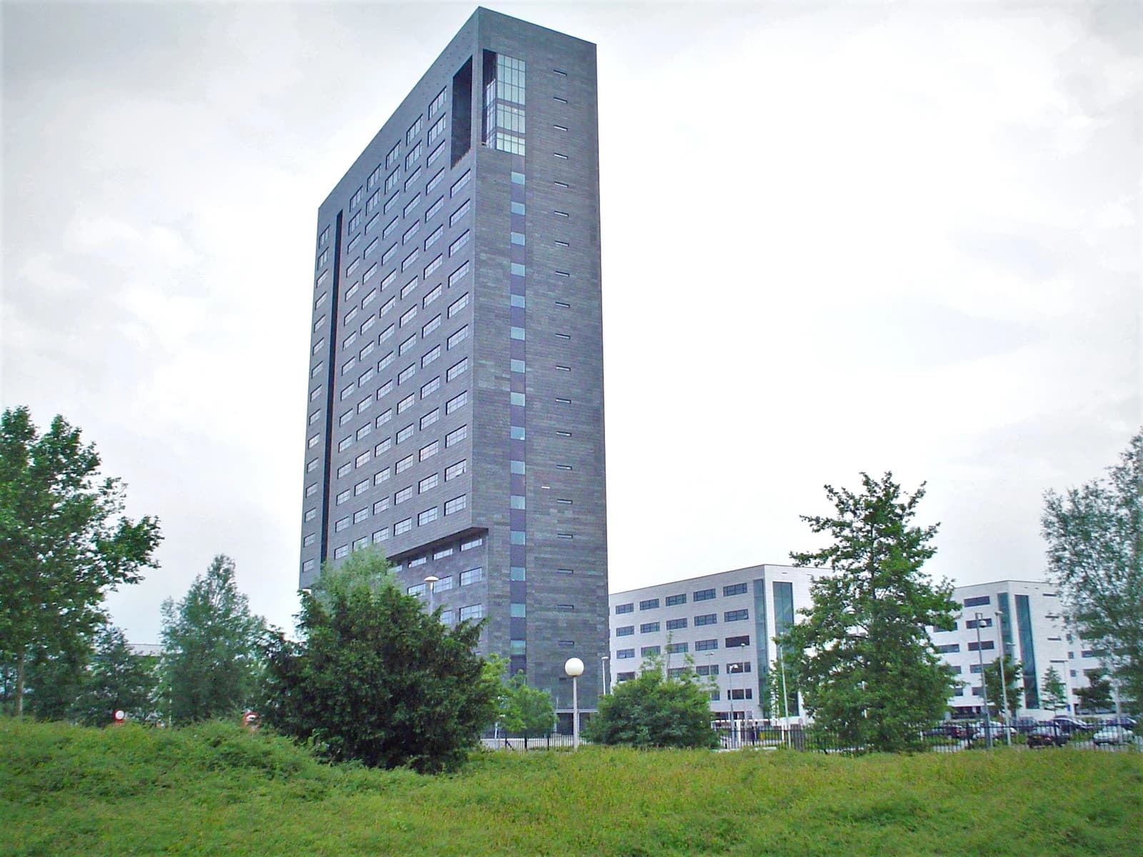 ASML headquarters building, a tall modern structure with many windows, in Veldhoven.