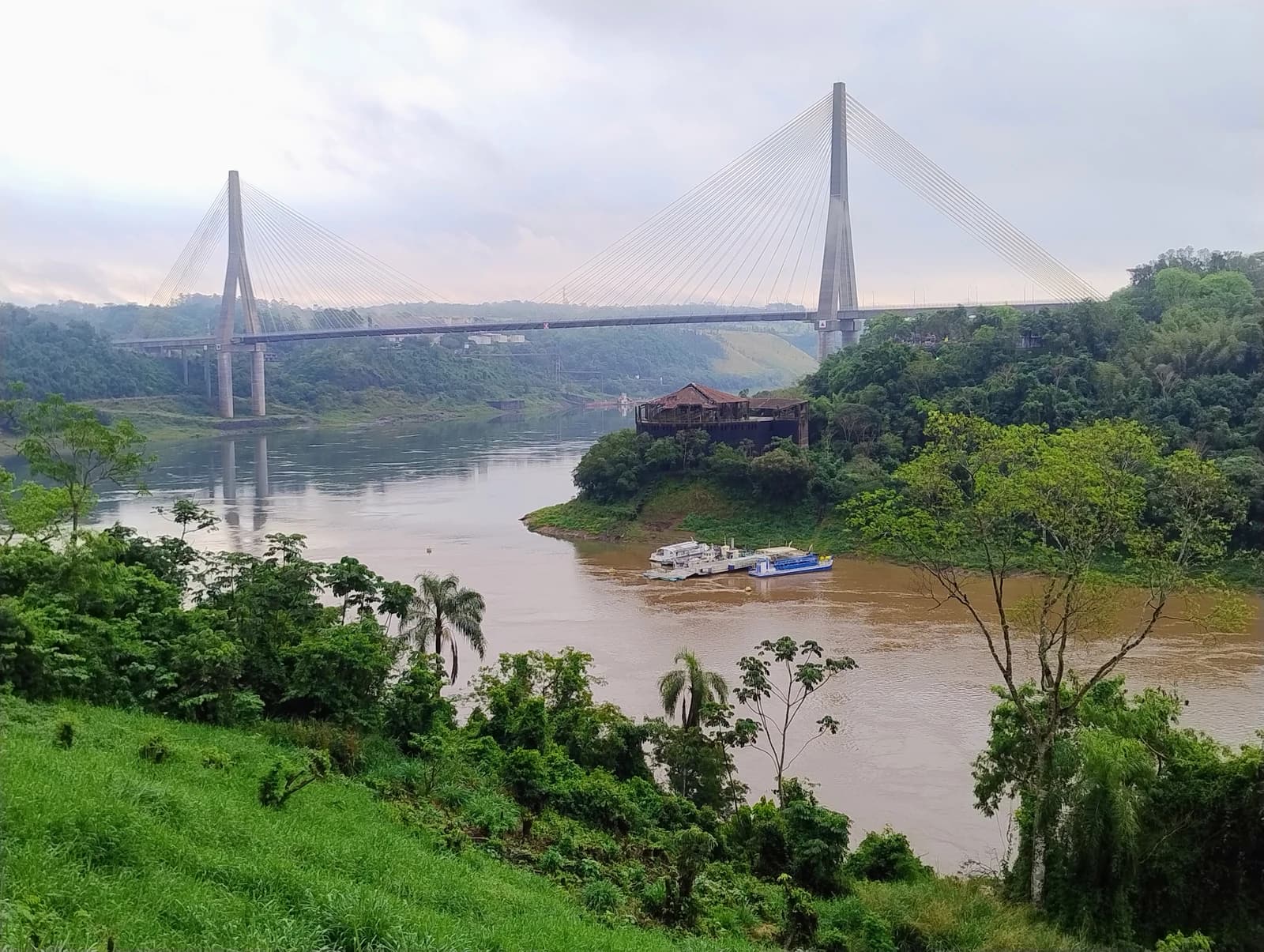 Integration Bridge connecting Brazil and Paraguay over a muddy river.