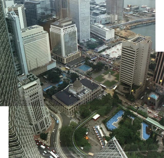 Aerial view of Hong Kong's Central district with numerous skyscrapers and roads.