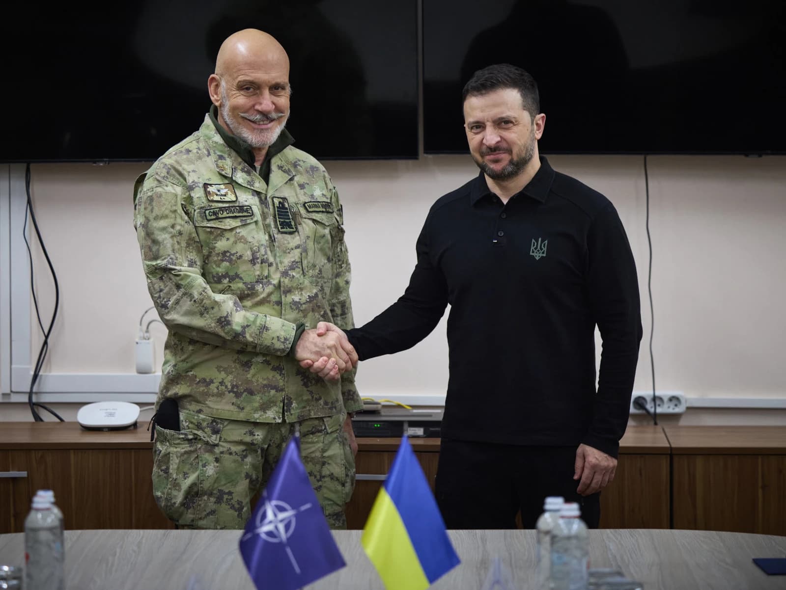 President Volodymyr Zelensky shakes hands with Giuseppe Cavo Dragone in Ukraine.