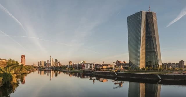 Seat of the European Central Bank and the Frankfurt skyline at dawn.