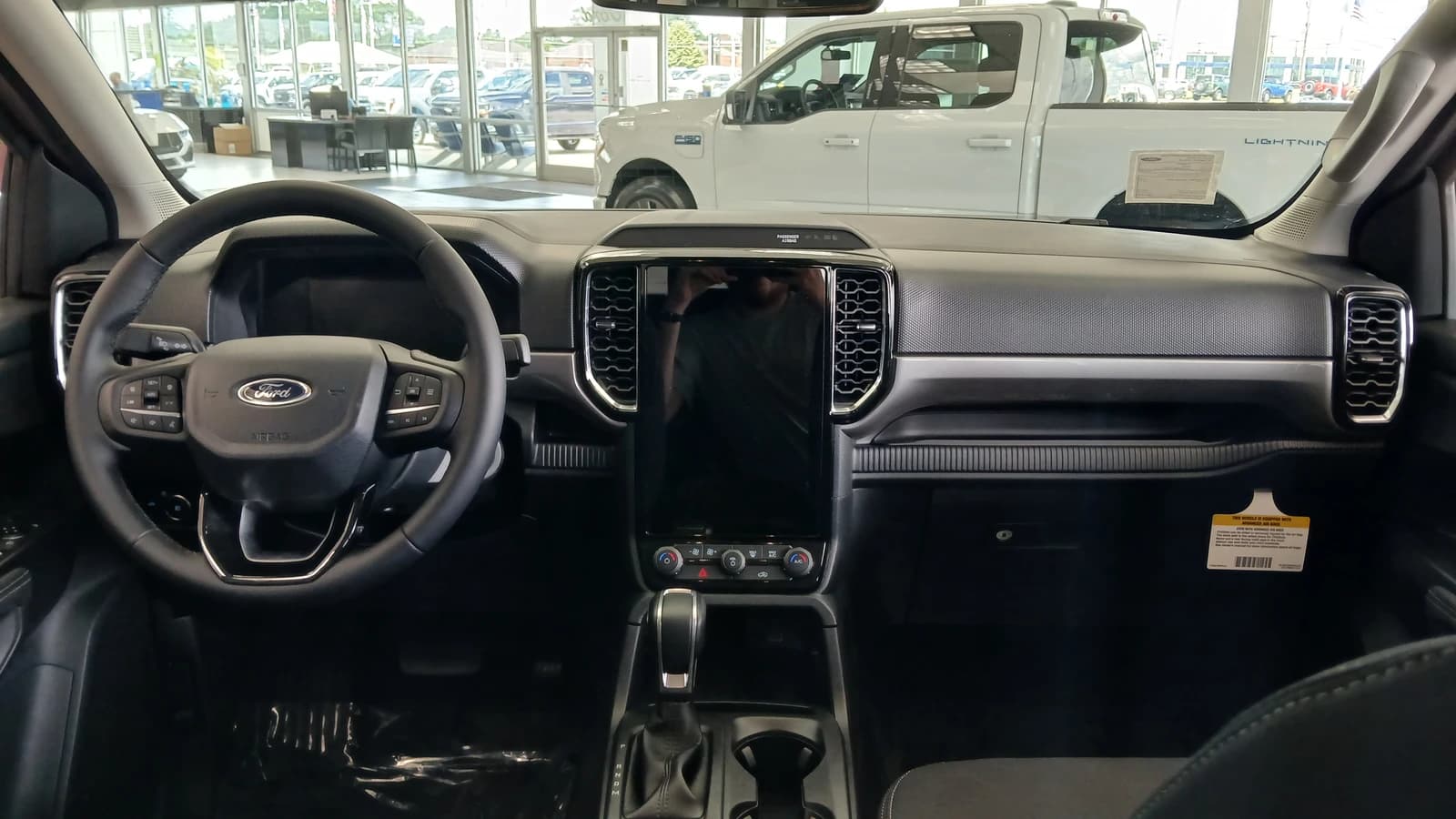 Interior of a 2024 Ford Ranger showing dashboard, steering wheel, and large central screen.
