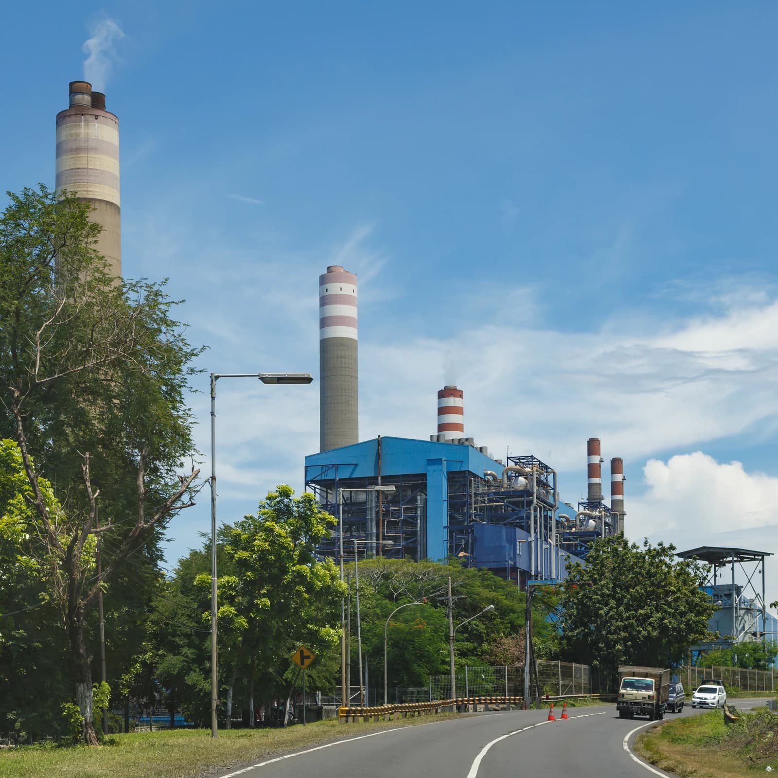 Paiton thermal power plant in Java, Indonesia, featuring industrial buildings and smokestacks.