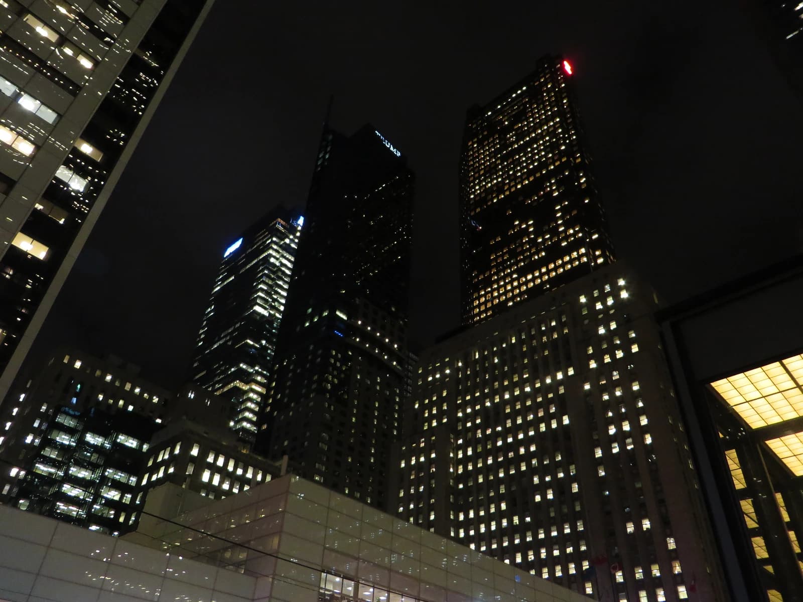 Skyscrapers including Scotia Plaza and Trump Tower illuminated at night in Toronto, Canada.