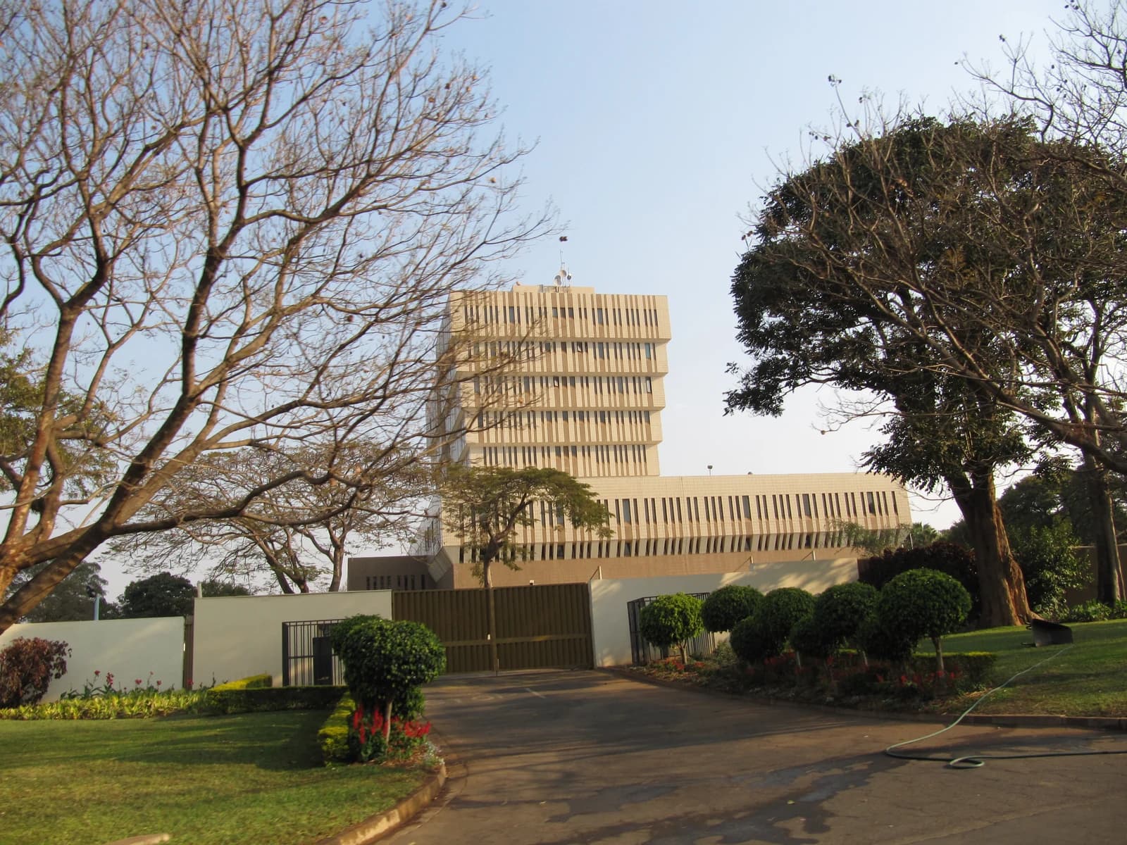 Exterior view of the National Bank of Malawi building in Lilongwe, framed by trees.