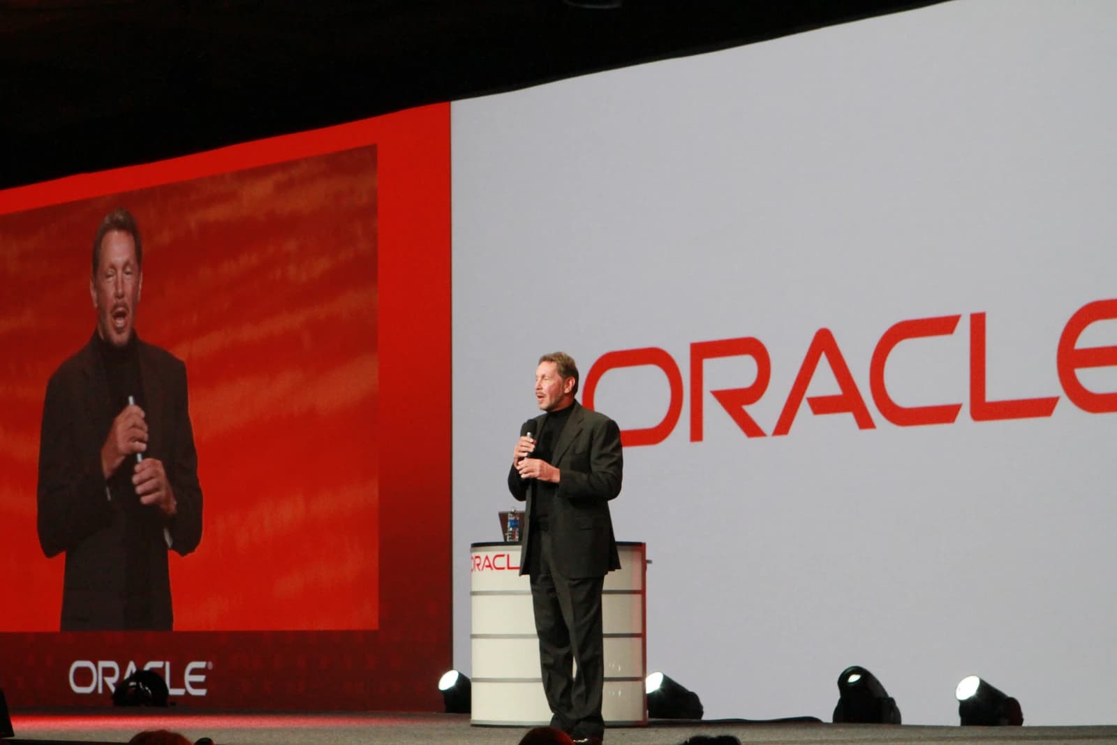 Larry Ellison, CEO of Oracle, speaks on stage at a conference.