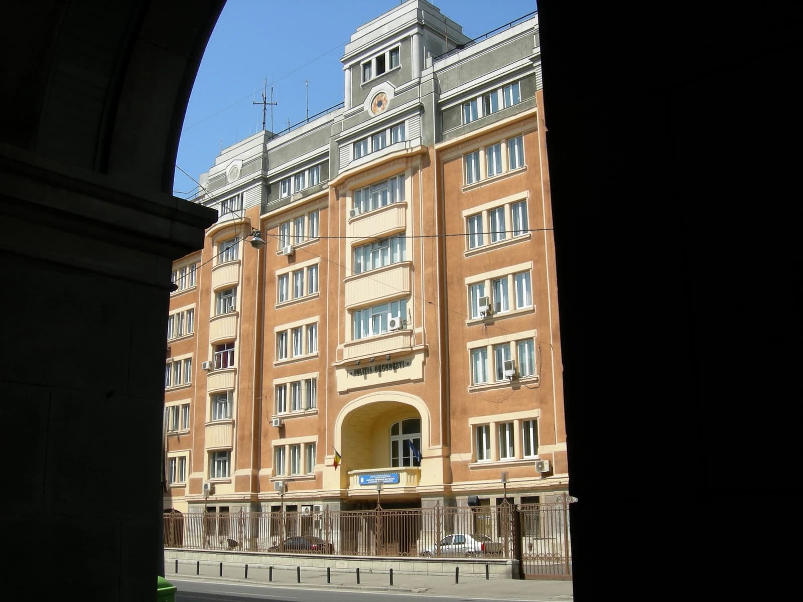 Bucharest Police Headquarters building, a multi-story structure with a arched entrance.