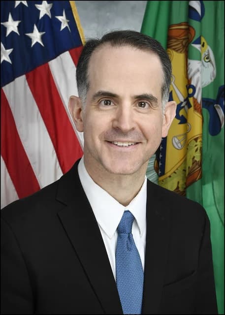 Joshua Frost, Assistant Secretary of the Treasury, smiles in an official portrait.