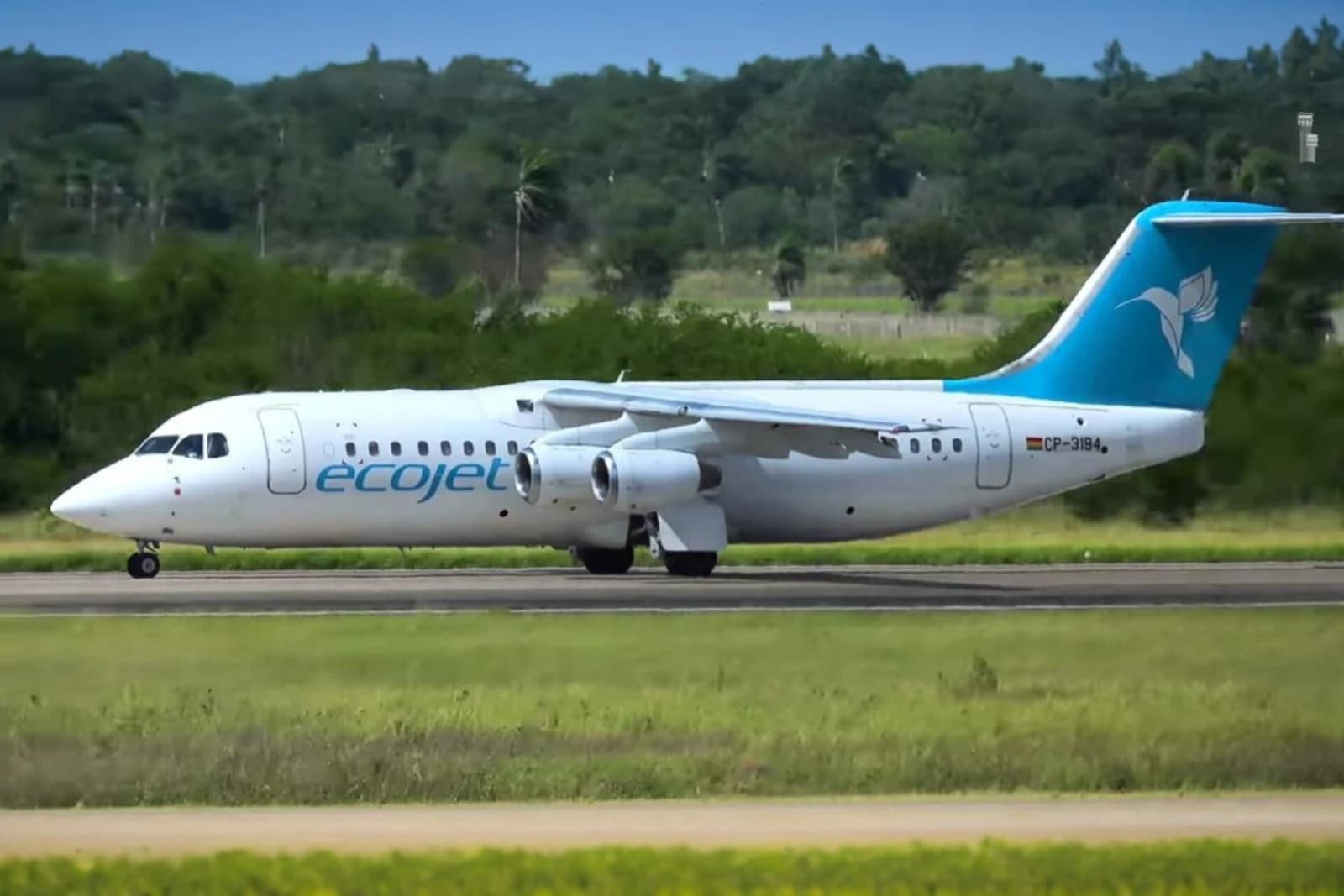 An Ecojet Avro RJ100 aircraft is on the tarmac at Viru Viru International Airport.