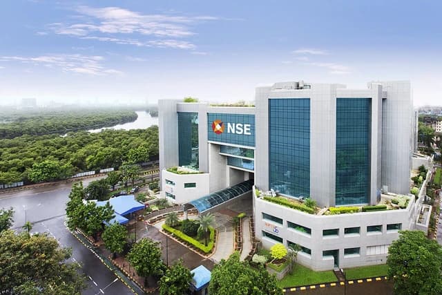 NSE Exchange Plaza building in Mumbai, India, with surrounding greenery and a river.