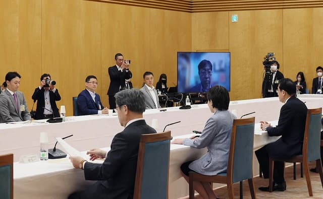 Yutaka Matsuo, Atsushi Okada, Yohei Sadoshima, and Hiroaki Kitano seated at a long conference table.
