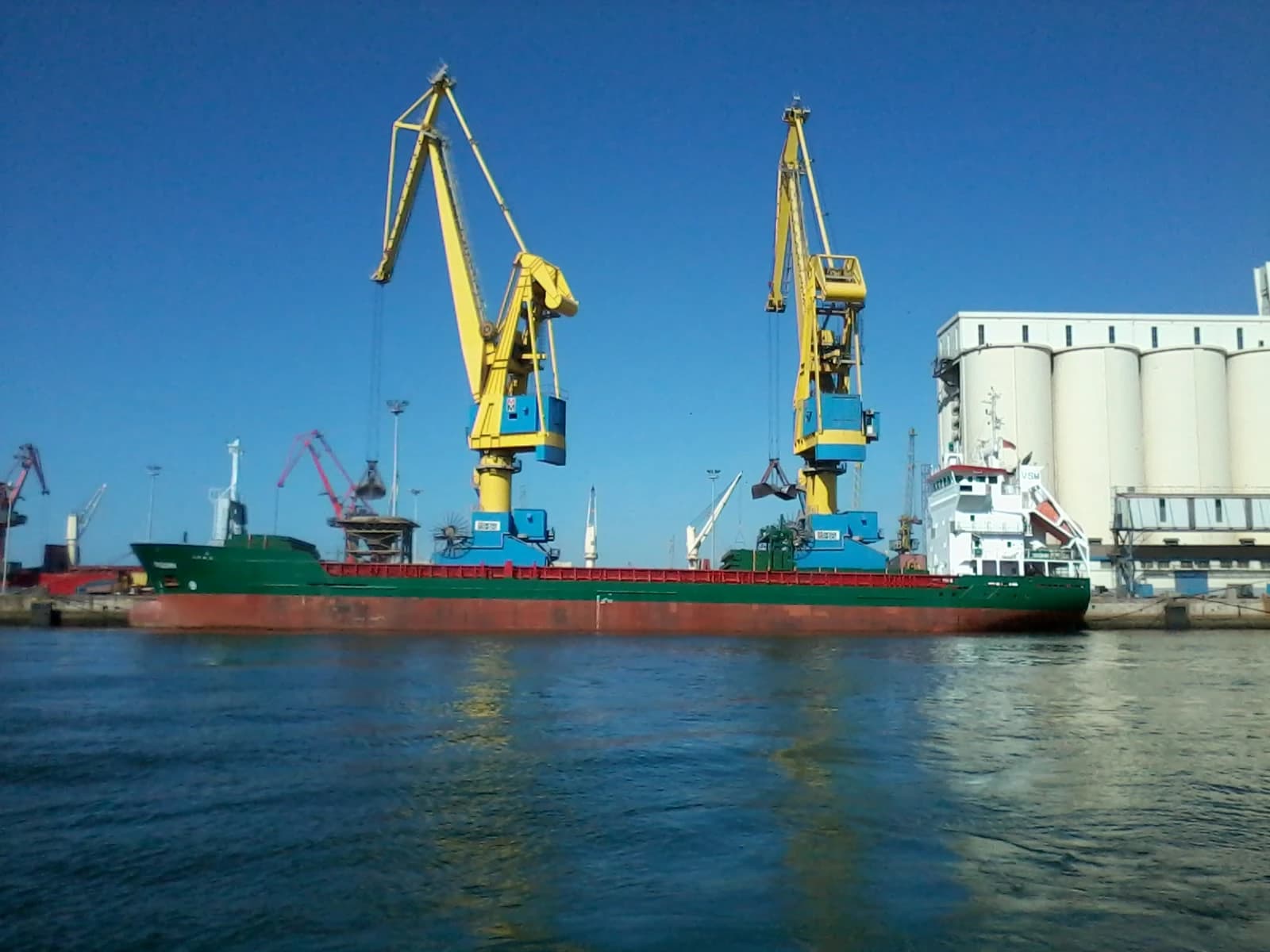 A cargo ship docked at the port of Casablanca, Morocco, with large cranes.