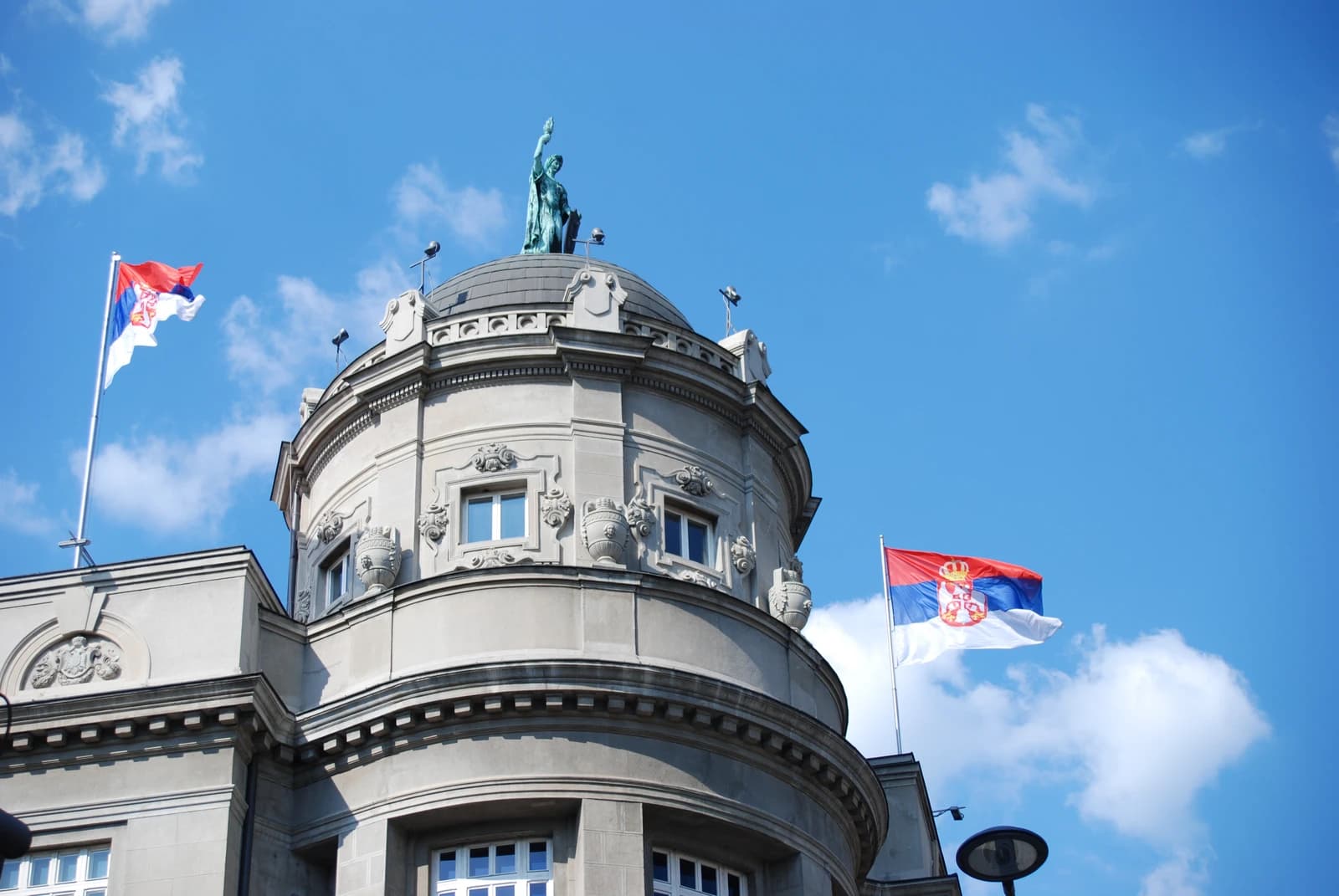 Dome of the Government Building in Belgrade, Serbia, with two Serbian flags flying.