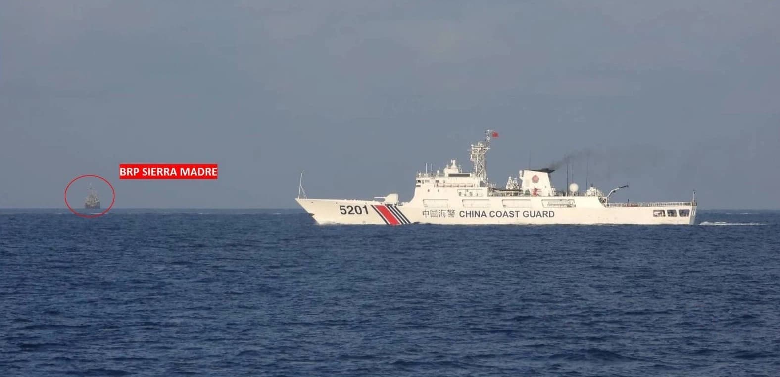 China Coast Guard vessel 5201 sailing alongside BRP Sierra Madre on the open sea.