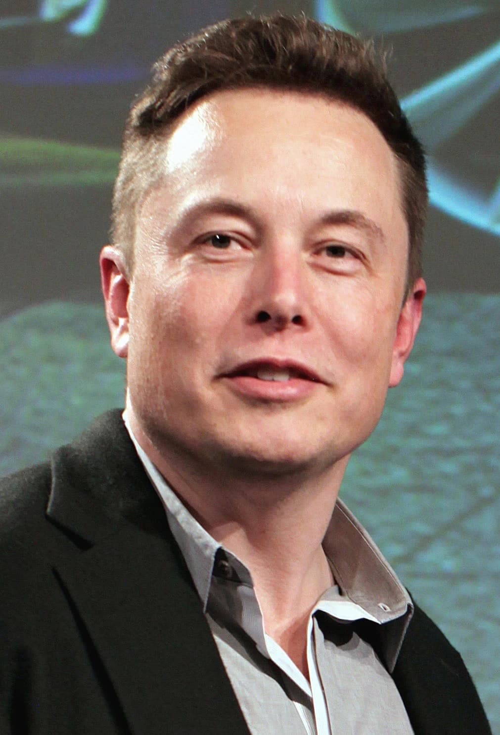 Elon Musk, CEO of Tesla and SpaceX, looking towards the viewer.