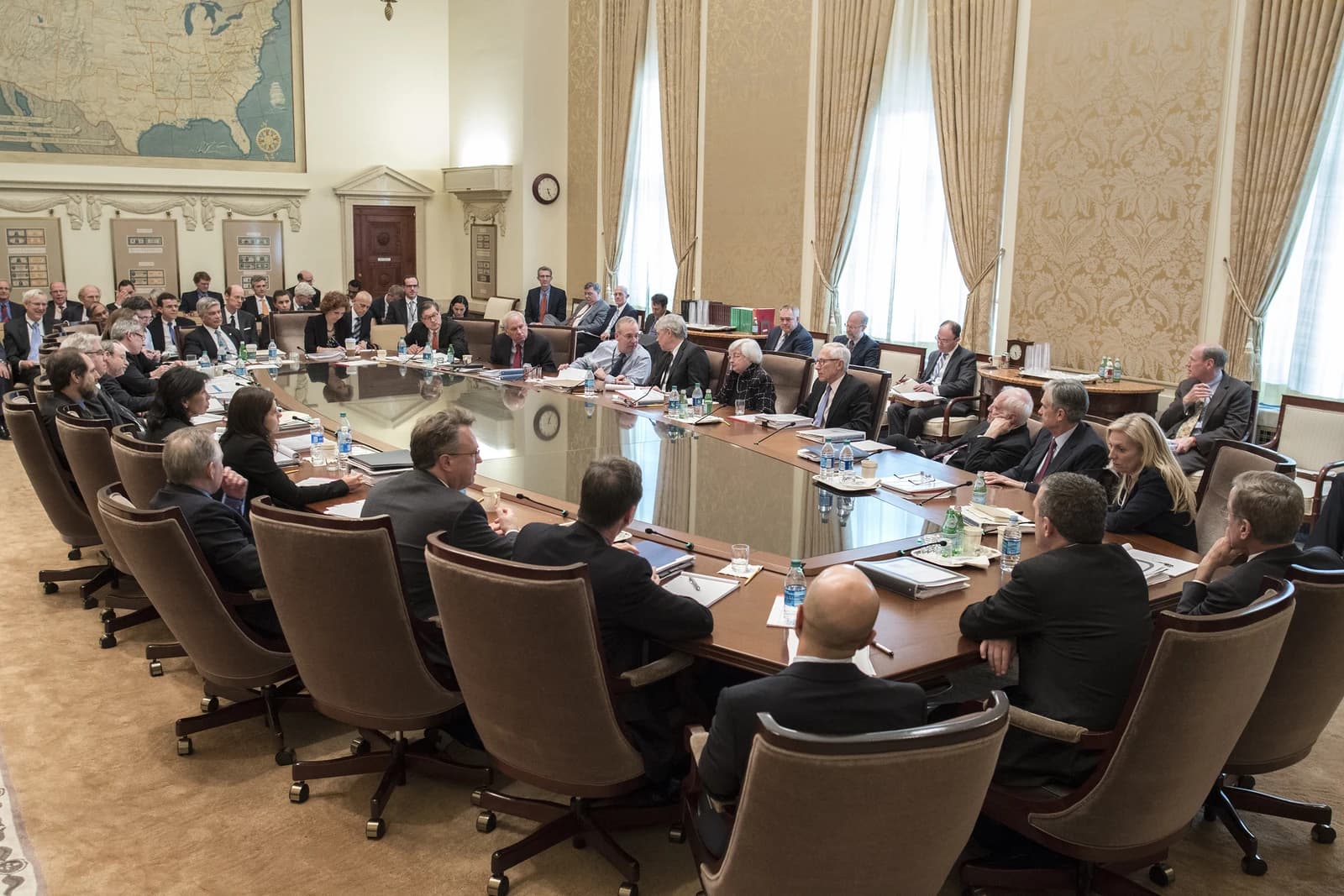 Members of the Federal Open Market Committee meeting around a large conference table.