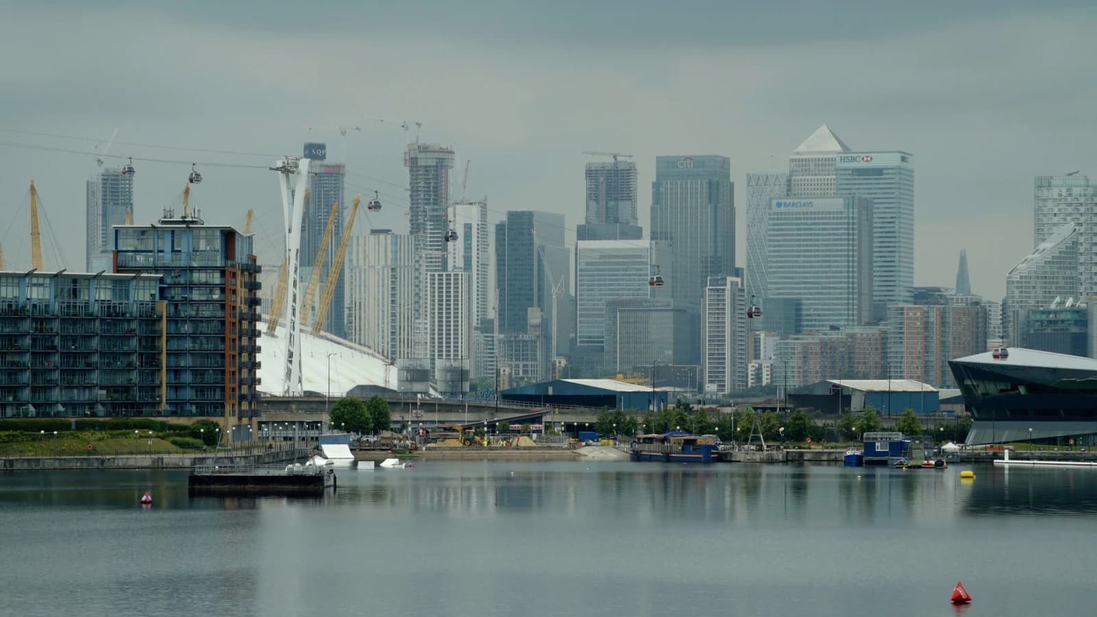 London skyline featuring the O2 Arena and Canary Wharf financial district across the River Thames.