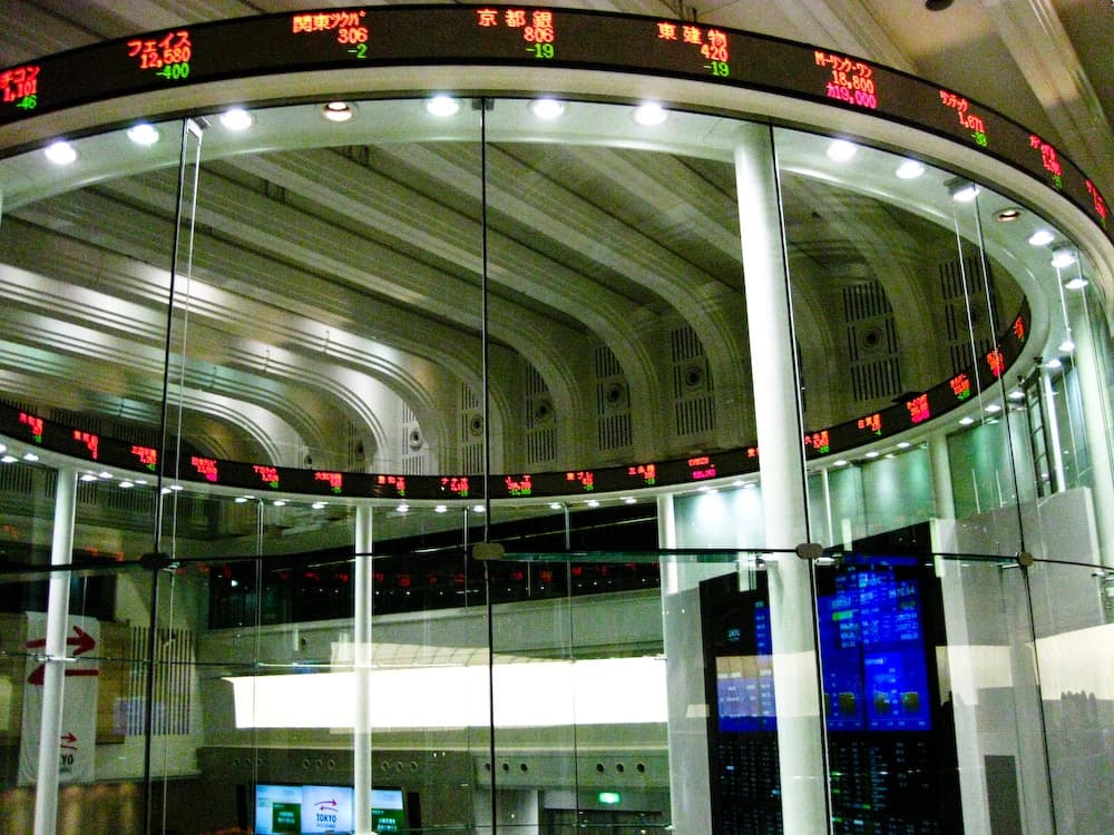 Interior of the Tokyo Stock Exchange market center, showing electronic ticker displays.