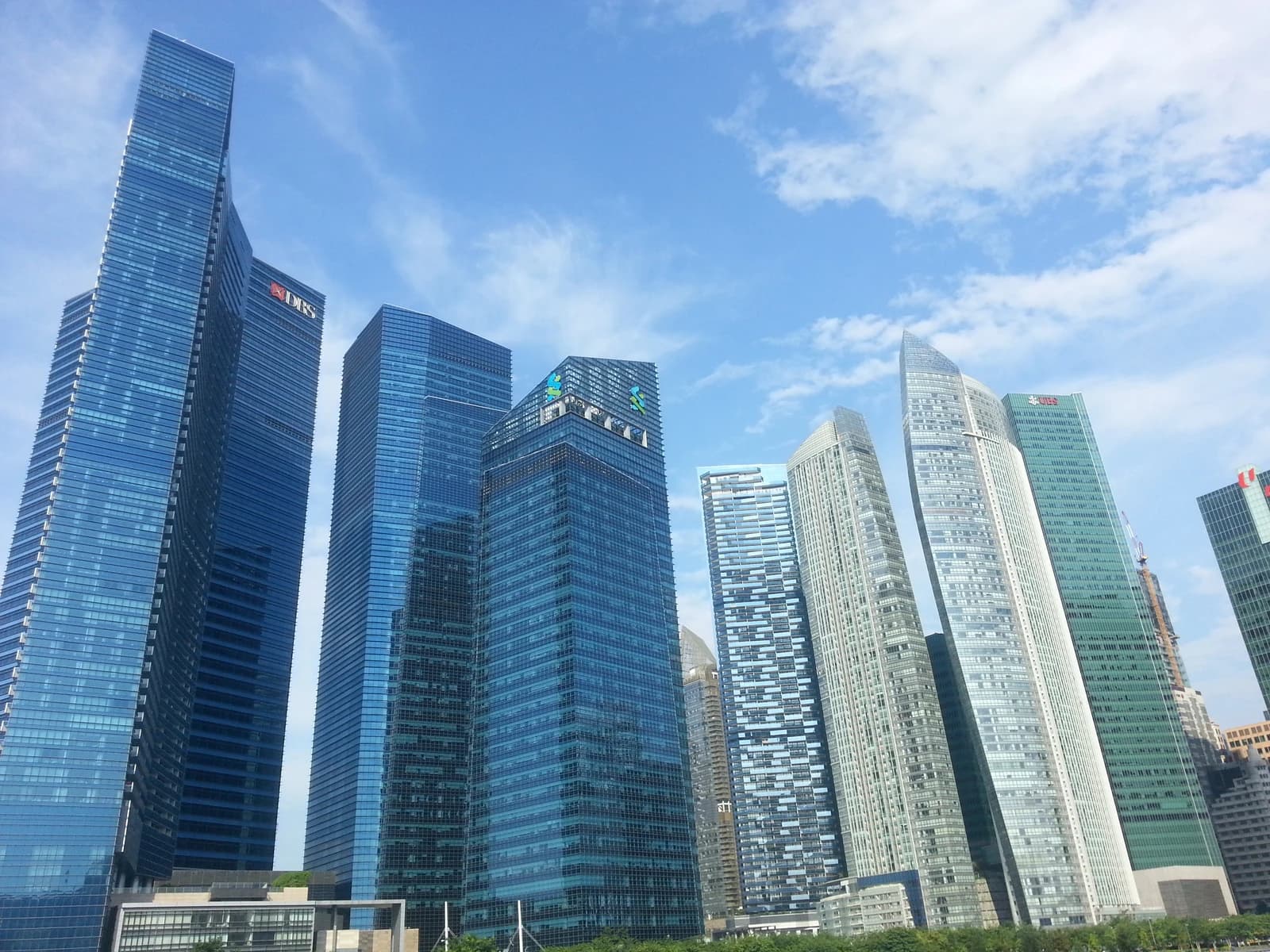 Singapore skyscrapers including Marina Bay Financial Centre, Asia Square, The Sail, and One Raffles Quay.