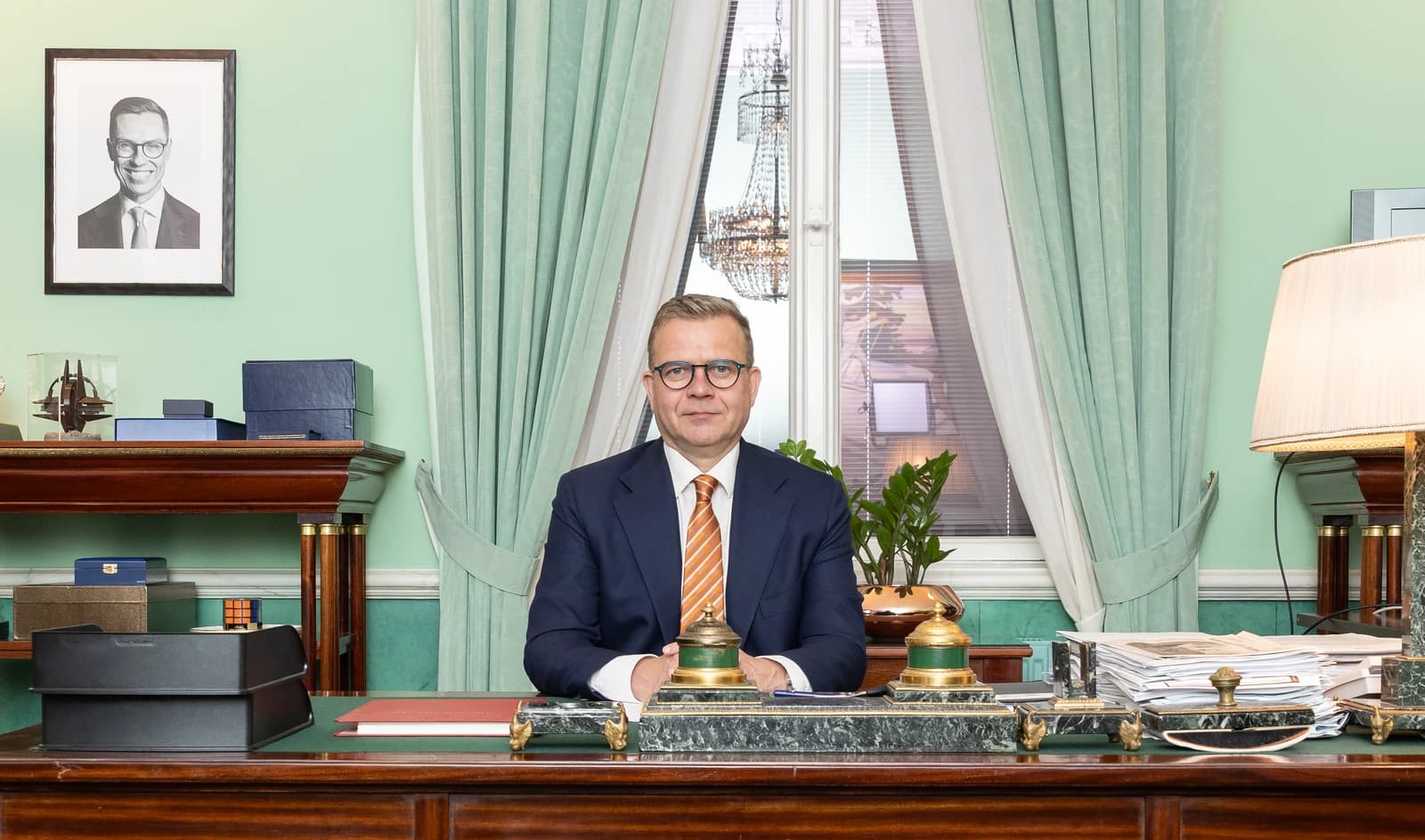 Petteri Orpo, Prime Minister of Finland, seated at his desk.