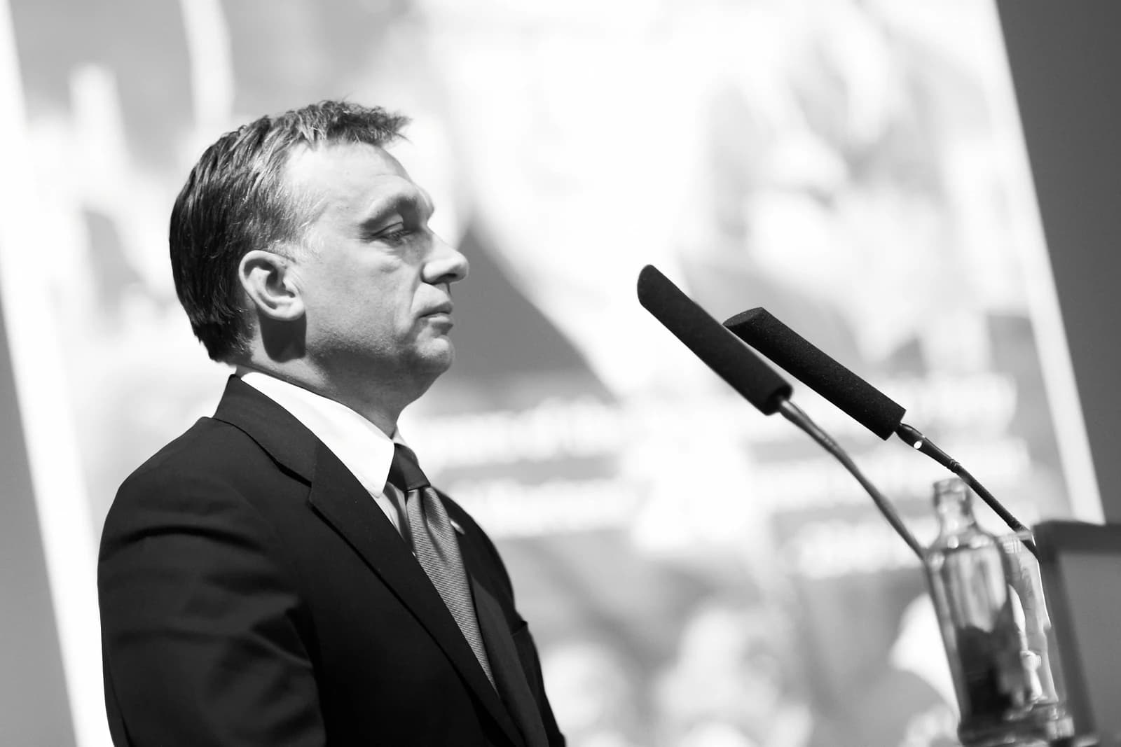 Viktor Orbán, Prime Minister of Hungary, standing beside microphones.